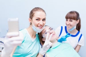 Doctors are taking selfies next to womens vaginas while 