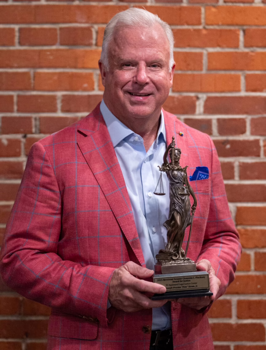 Pete Strom holding the South Carolina Appleseed 2025 Advocate of the Year Rev Sen Clmenta C Pinckney Award for Justice